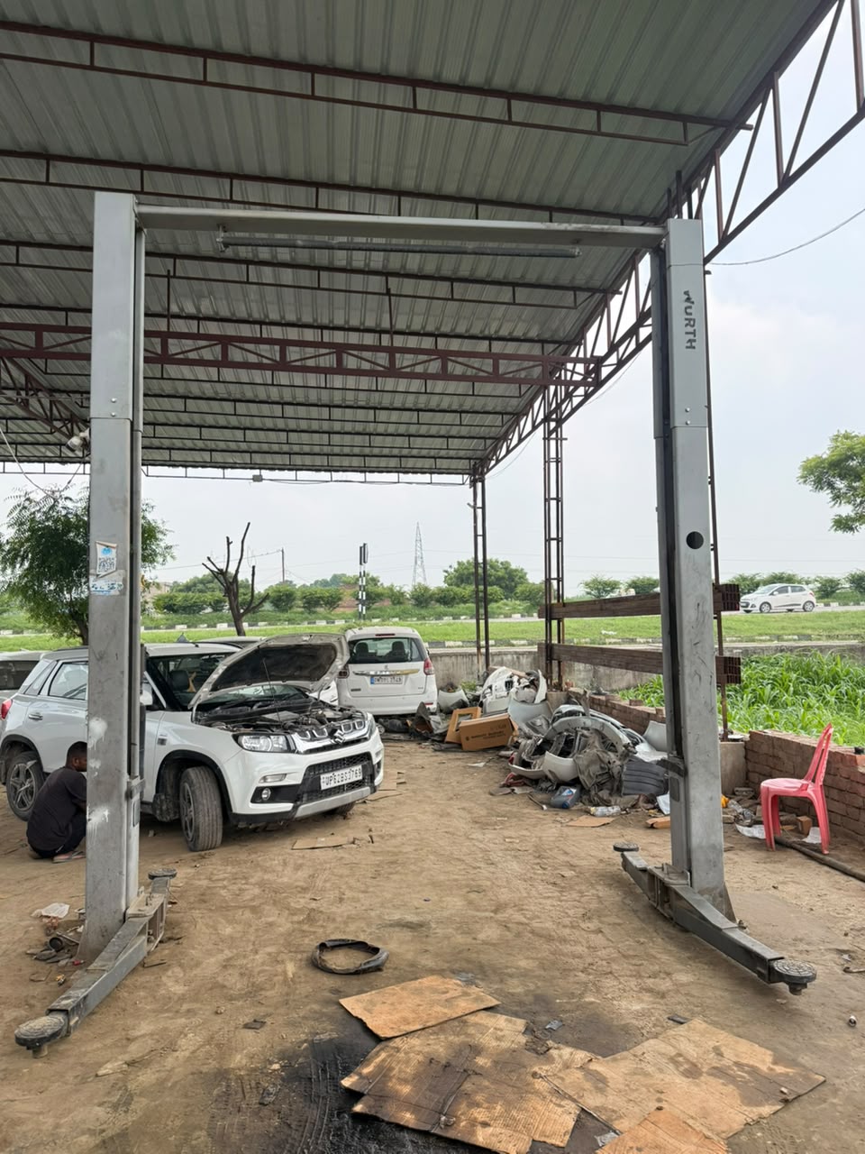 Engine oil change in progress at Lucky Automobile Workshop Jaunpur